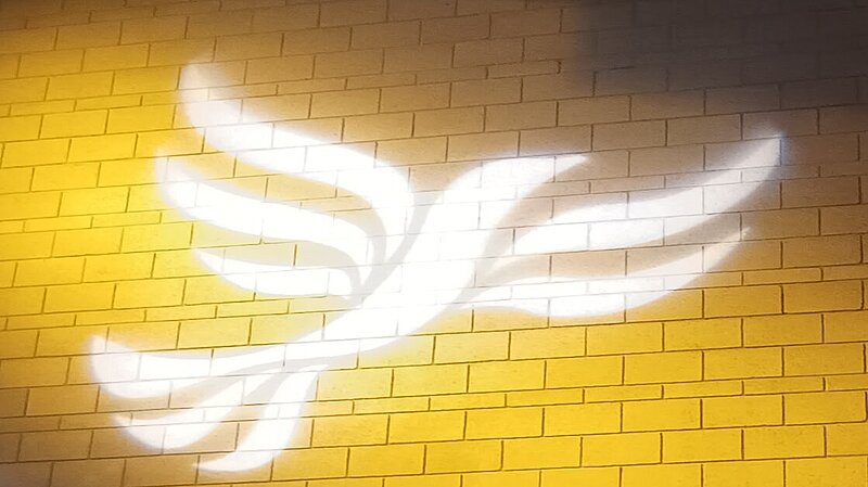Lib Dem logo bird projected on blockwork